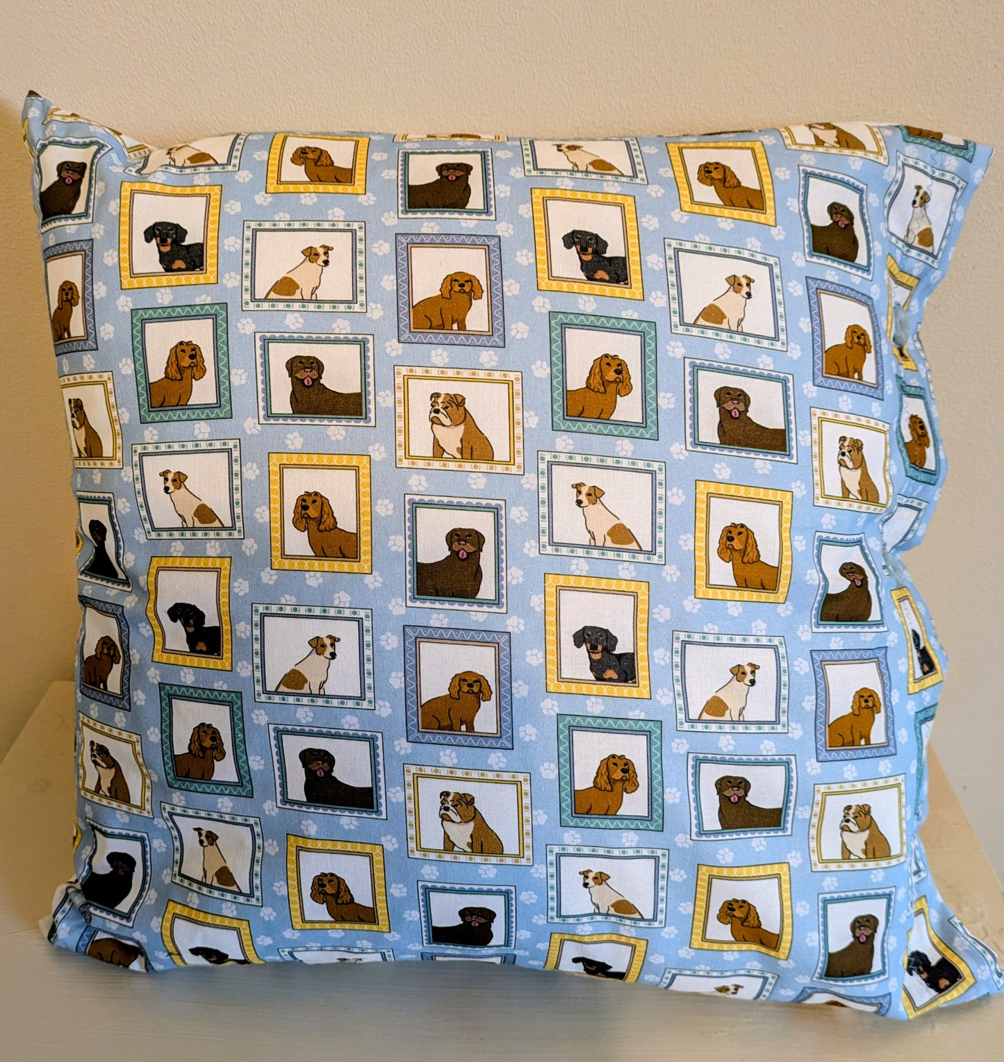 Dog print cushion by Harrie's Crafts featuring a cozy fabric cover with playful dog illustrations.