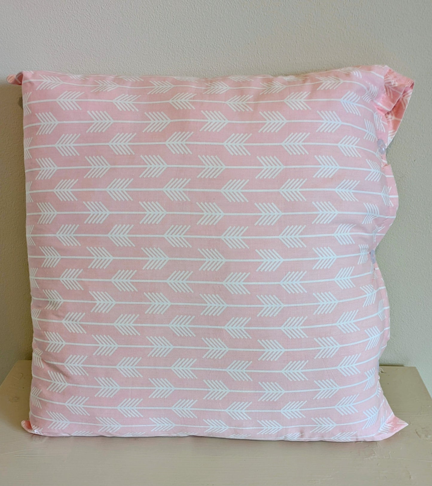 Pink cushion by Harrie's Crafts with soft fabric and decorative stitching, perfect for cozy home decor.