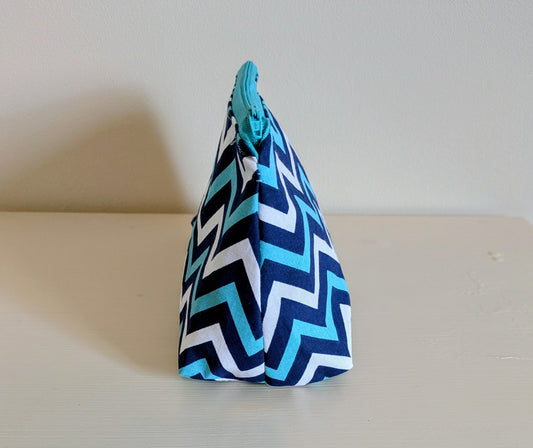 Blue and white zigzag waterproof wash bag by Harrie's Crafts, with a compact design and durable fabric for travel use.