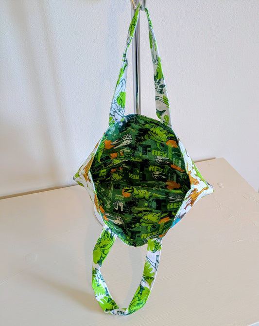 Harrie's Crafts dinosaur tote bag featuring a colorful dinosaur print on durable fabric with sturdy handles.