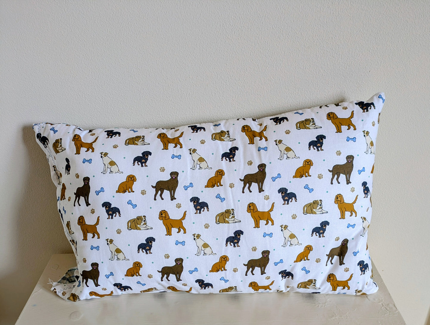 Harrie's Crafts dog pattern cushion showing a colorful fabric with playful dog illustrations and soft padding.