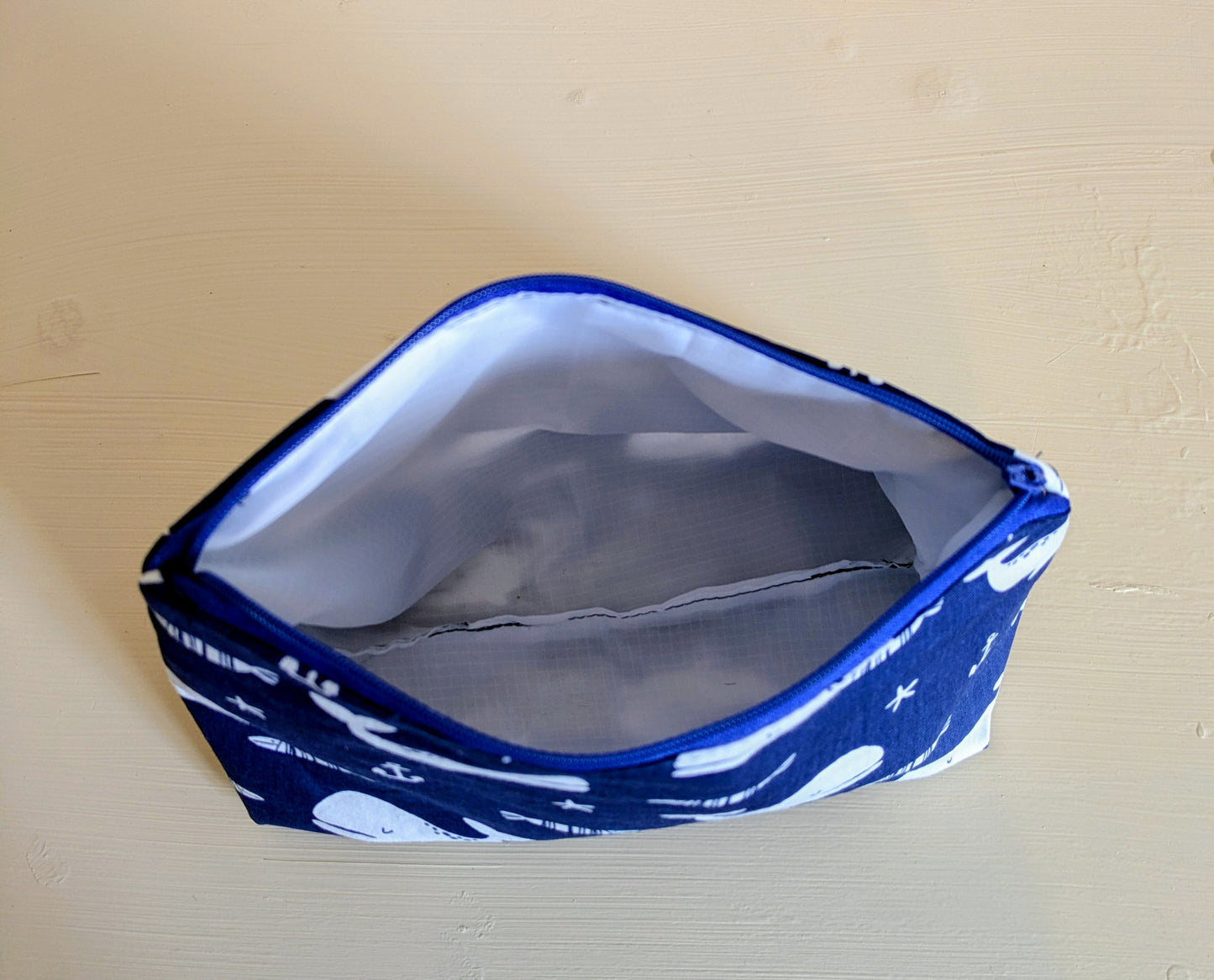 White and blue whale wash bag by Harrie's Crafts, featuring a cute whale design and spacious interior for travel essentials.