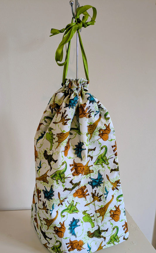 Dinosaur waterproof drawstring bag by Harrie's Crafts featuring colorful dinosaur illustrations on durable fabric.