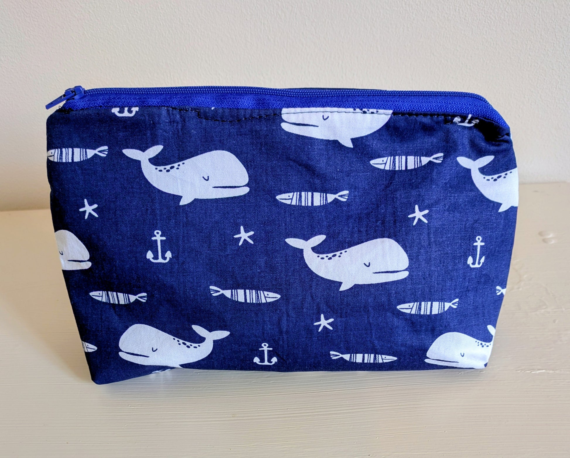White and blue whale wash bag by Harrie's Crafts with a cute whale design and zipper closure.