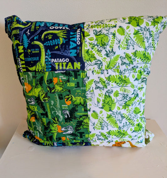 Colorful dinosaur patchwork cushion by Harrie's Crafts featuring vibrant fabric patches and soft, plush filling.