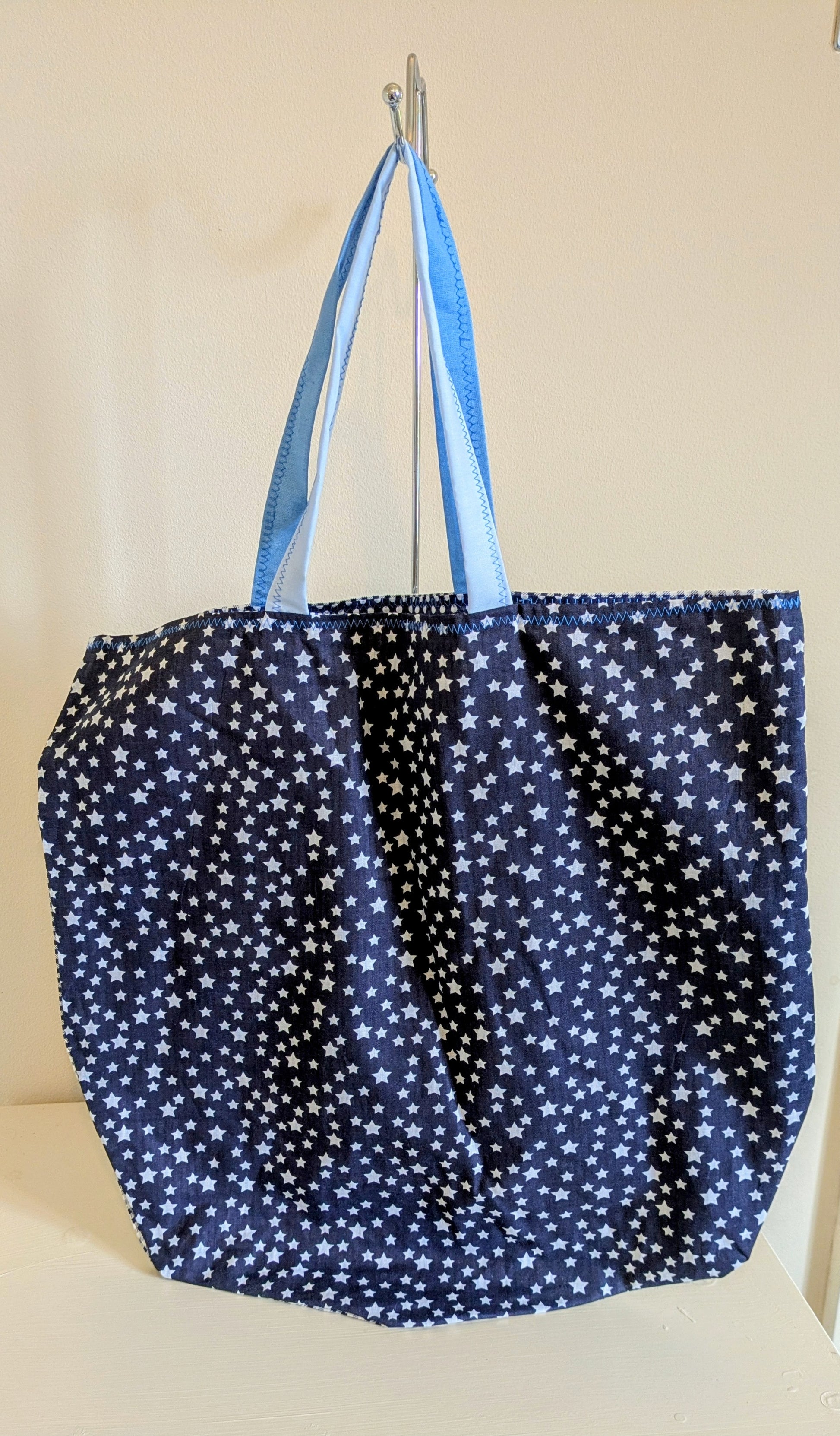 Blue tote bag from Harrie's Crafts with sturdy handles and spacious interior, perfect for everyday use.