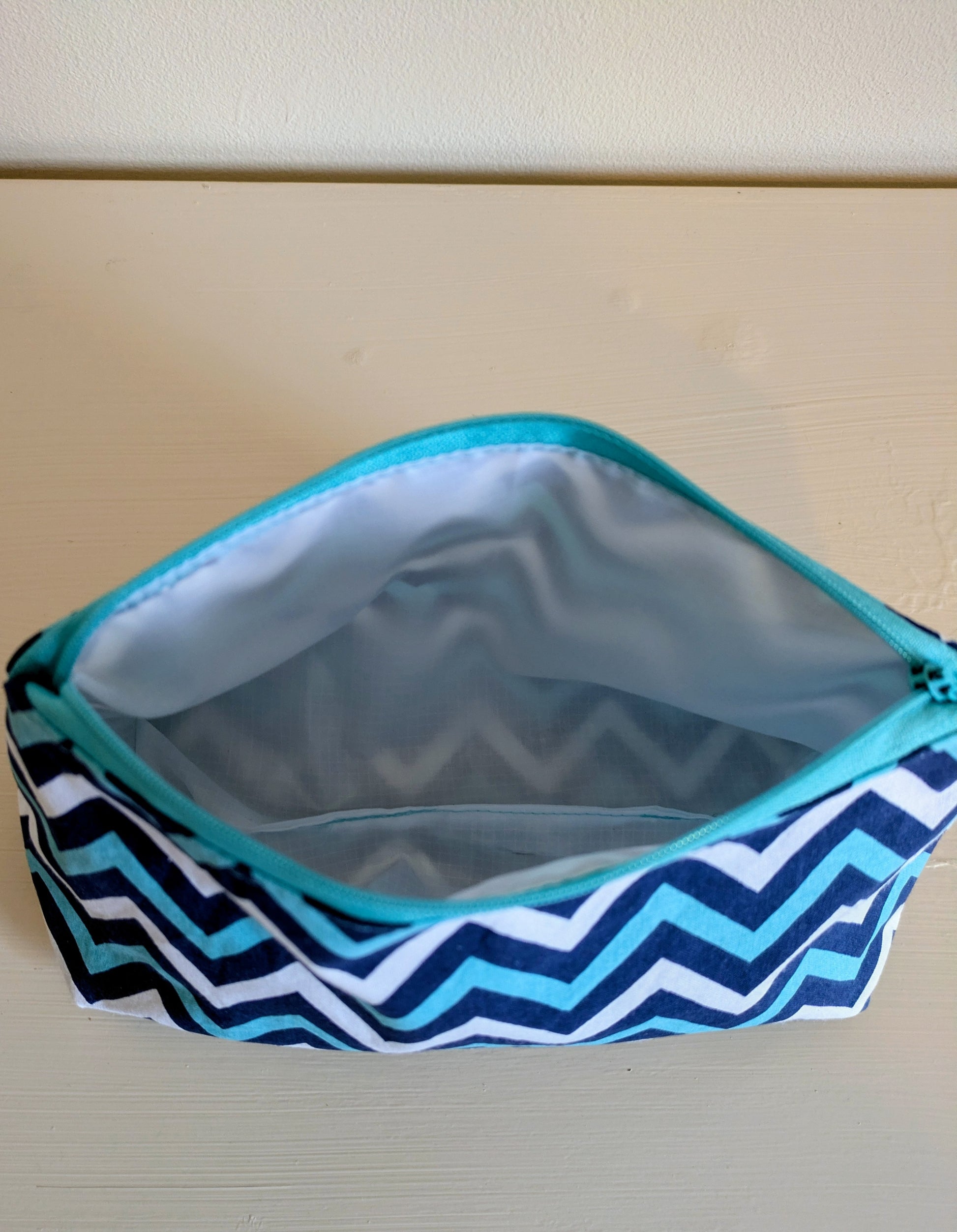 Cute blue and white zigzag waterproof wash bag by Harrie's Crafts, showing the fabric pattern and zipper closure.