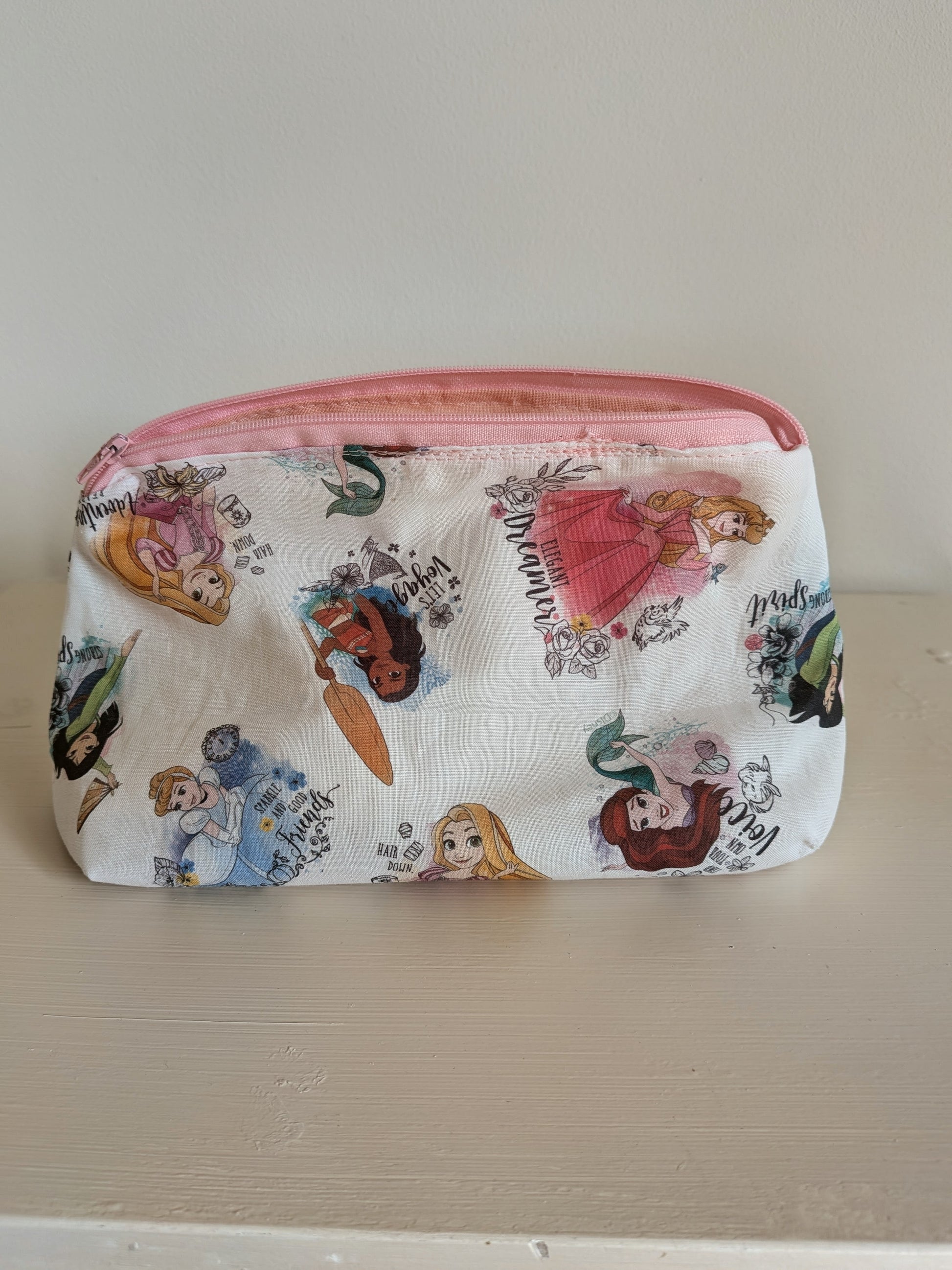 Harrie's Crafts princess wash bag with colorful princess design, zipper closure, and compact toiletry storage for travel.