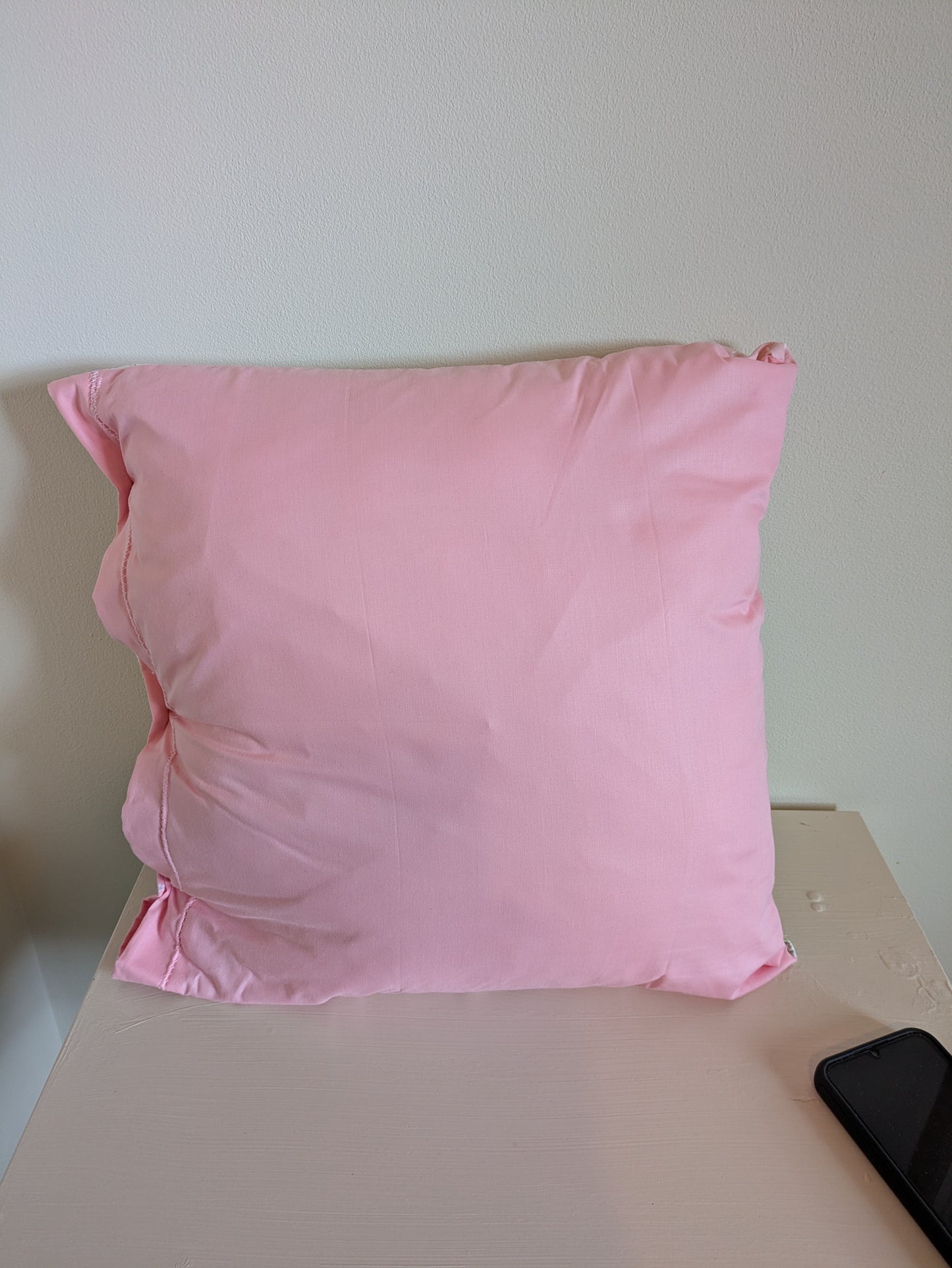 Pink flower patchwork cushion by Harrie's Crafts featuring vibrant floral fabric and soft filling for cozy comfort.