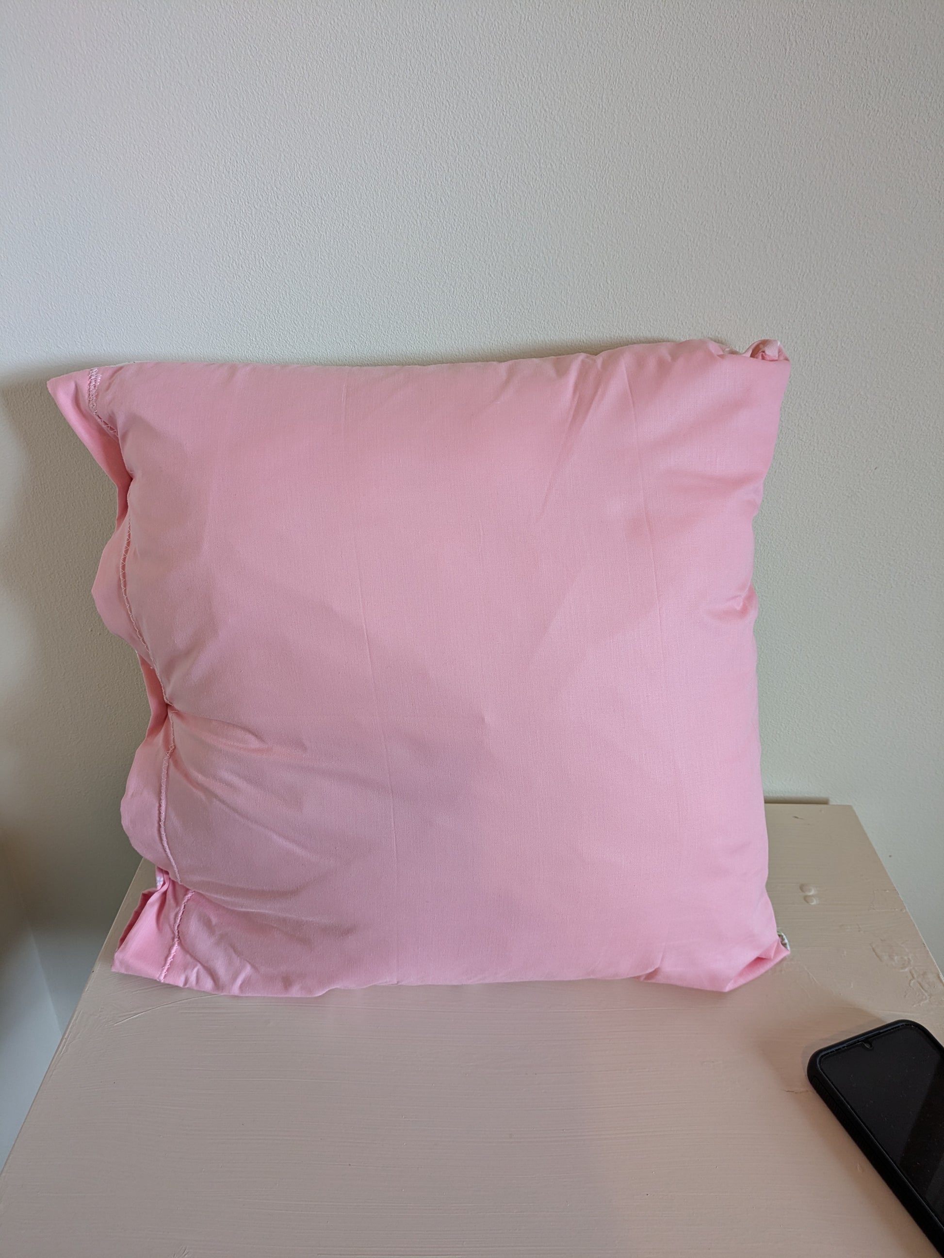 Pink flower patchwork cushion by Harrie's Crafts featuring vibrant floral fabric and soft filling for cozy comfort.
