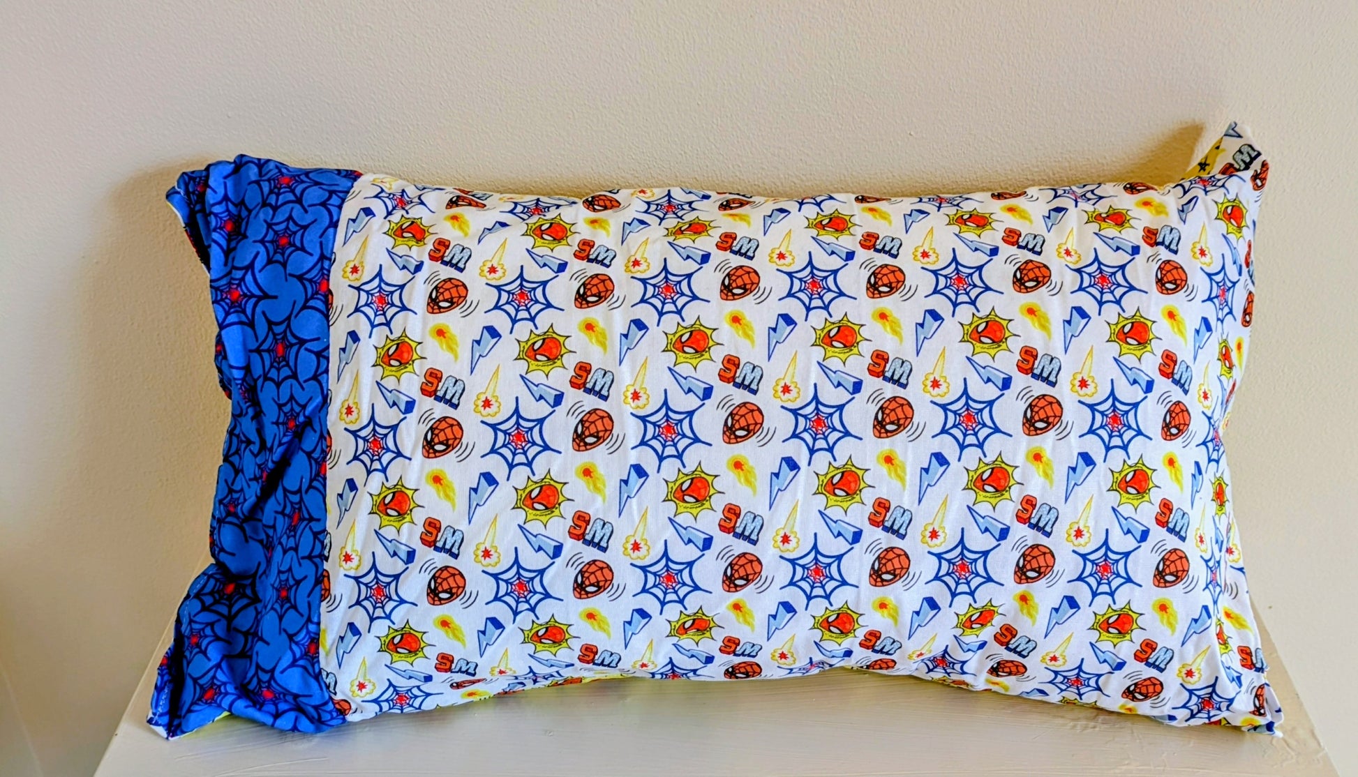 Spiderman patchwork cushion by Harrie's Crafts with colorful fabric patches and a playful superhero design.