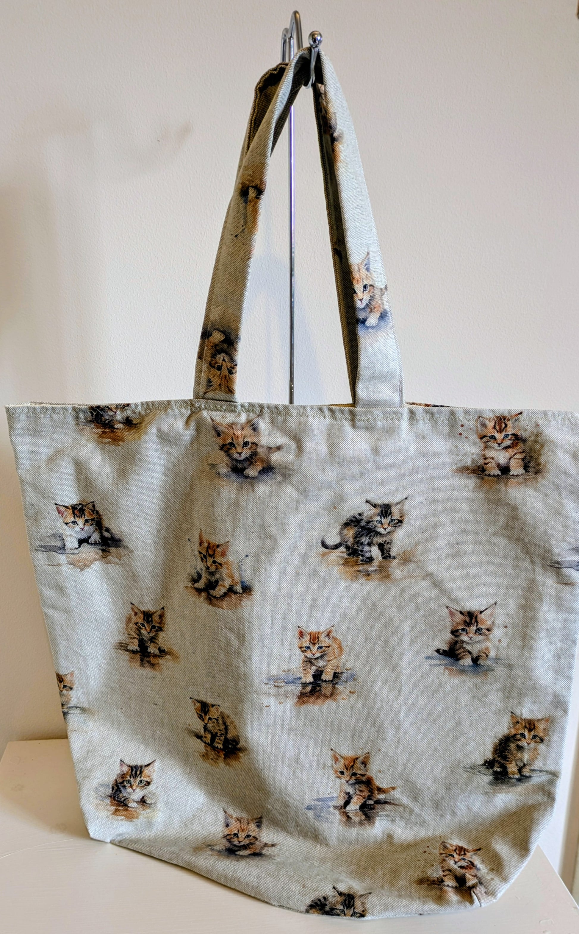Harrie's Crafts kitten tote bag with colorful cat illustration and sturdy fabric handles, perfect for carrying essentials.