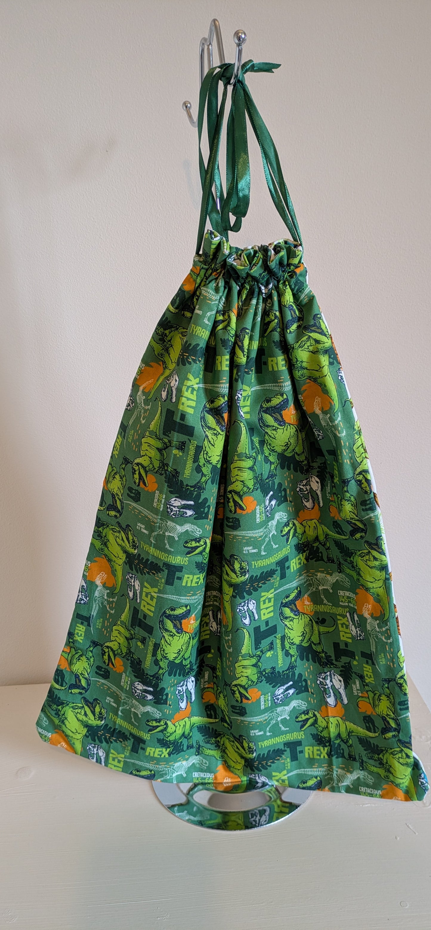Harrie's Crafts dinosaur drawing bag featuring colorful dinosaur illustrations on a spacious fabric bag.