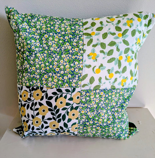 Colorful flower patchwork cushion by Harrie's Crafts featuring vibrant floral fabric and cozy design.