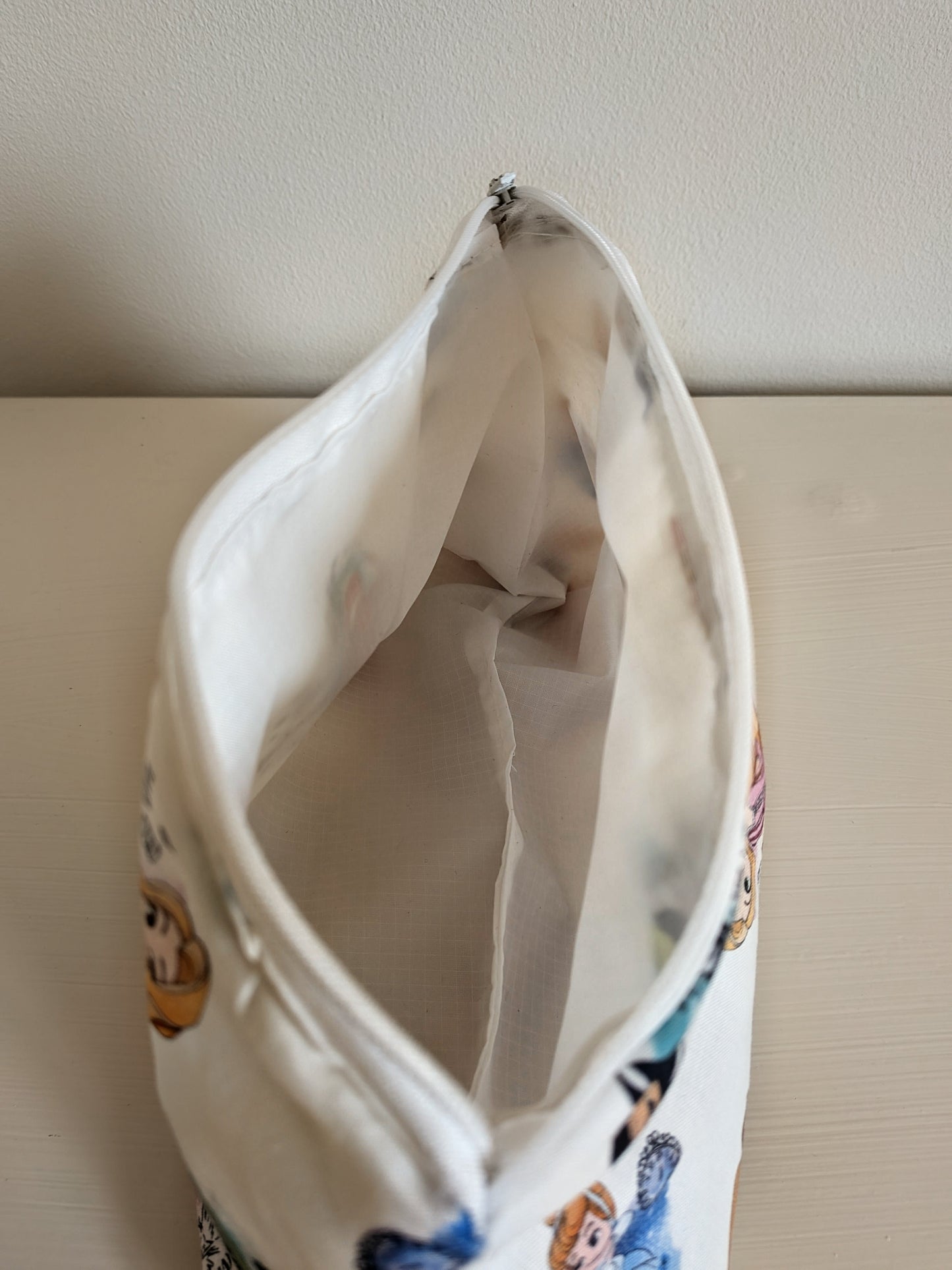 Harrie's Crafts princess wash bag with waterproof lining, featuring a colorful princess design and zip closure for toiletries.