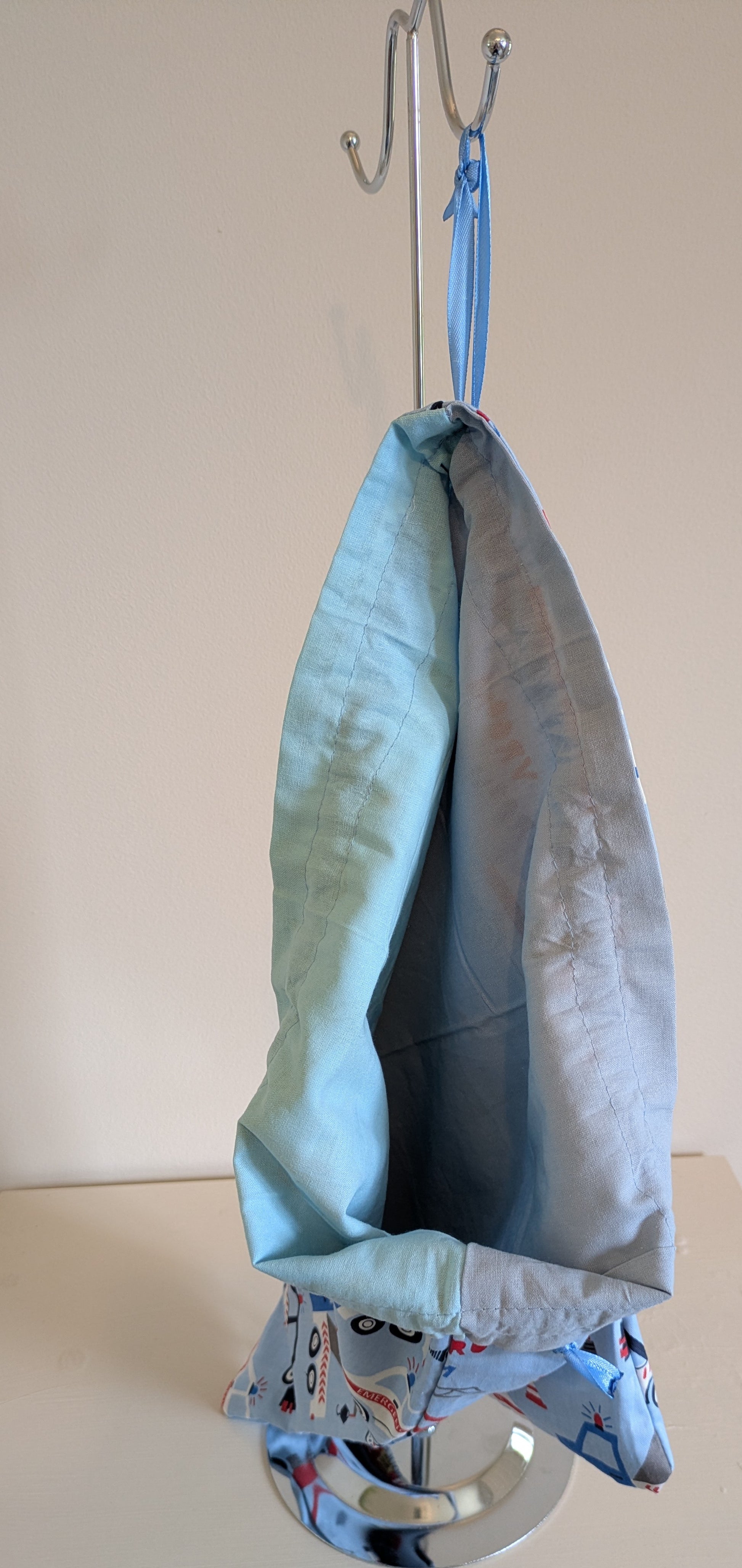 Harrie's Crafts transport drawstring bag made of durable fabric with black drawstrings and a spacious main compartment.