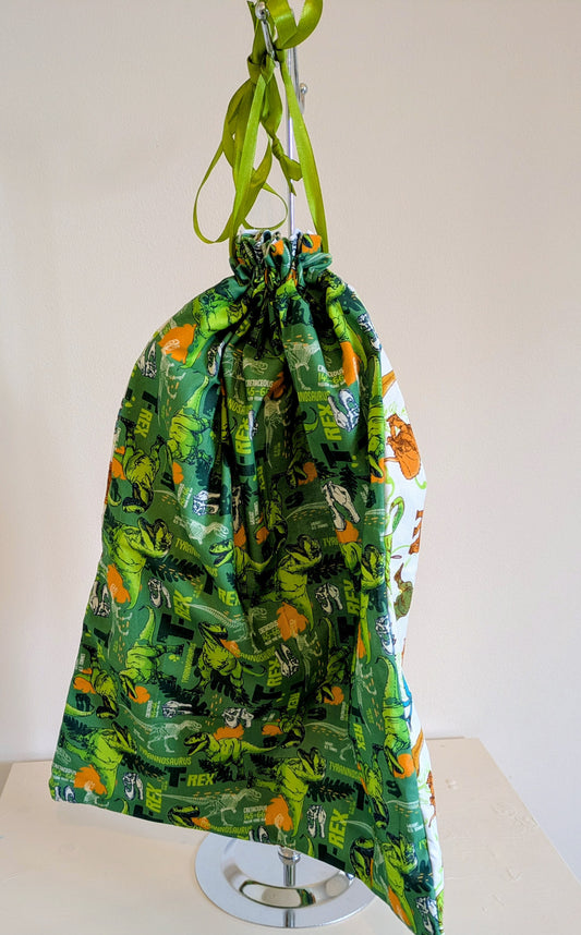 Harrie's Crafts dinosaur waterproof drawstring bag with colorful dinosaur print and adjustable drawstring closure.