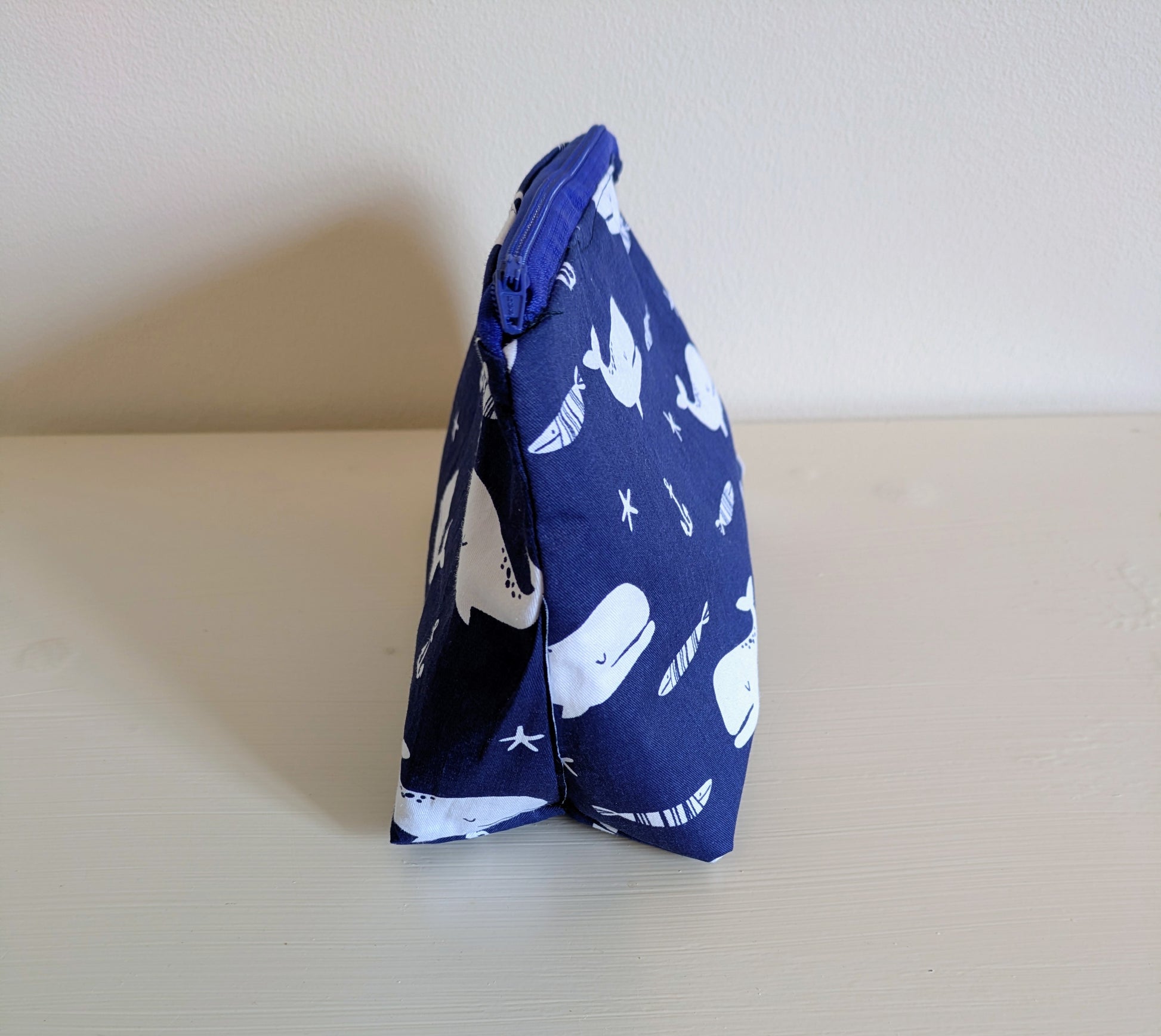 White and blue whale wash bag by Harrie's Crafts, featuring a cute whale design and spacious interior for toiletries.