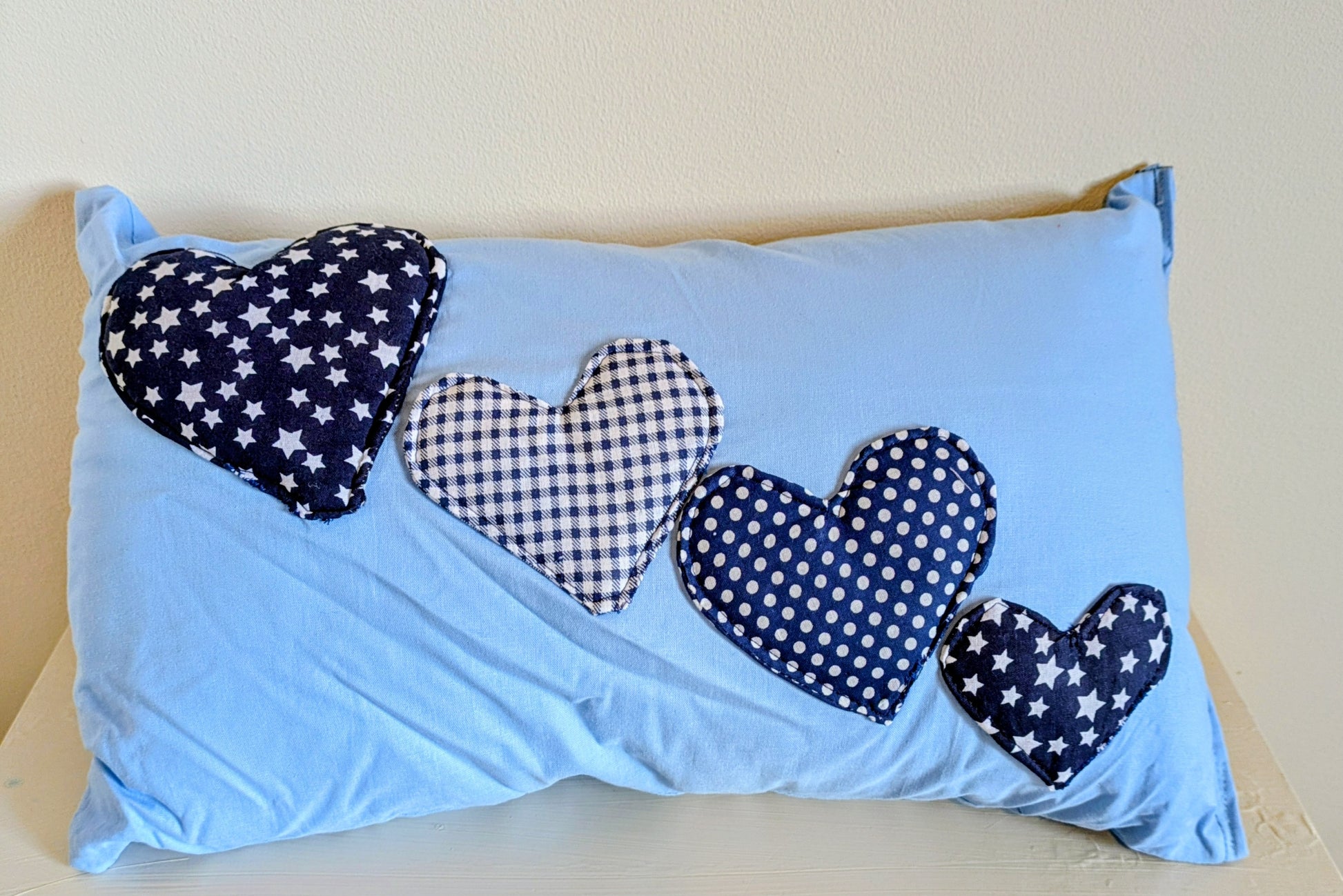 Harrie's Crafts heart-shaped cushion with soft fabric and decorative stitching, perfect for cozy home décor.