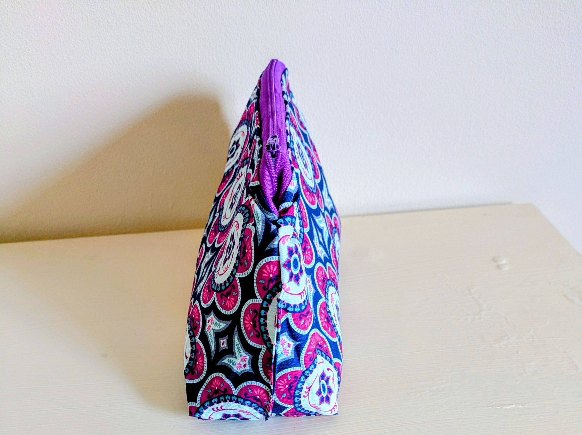 Colorful floral wash bag by Harrie's Crafts, featuring vibrant multi-color flower patterns on a fabric exterior.