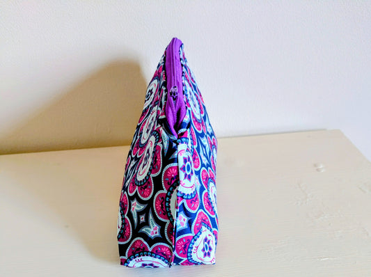 Colorful floral wash bag by Harrie's Crafts, featuring vibrant multi-color flower patterns on a fabric exterior.